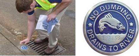 man placing storm drain marker on curb